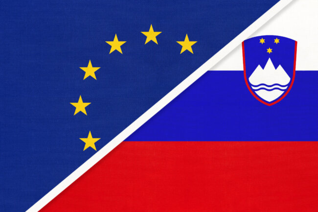 European Union or EU vs Slovenia national flag from textile. Symbol of the Council of Europe association.